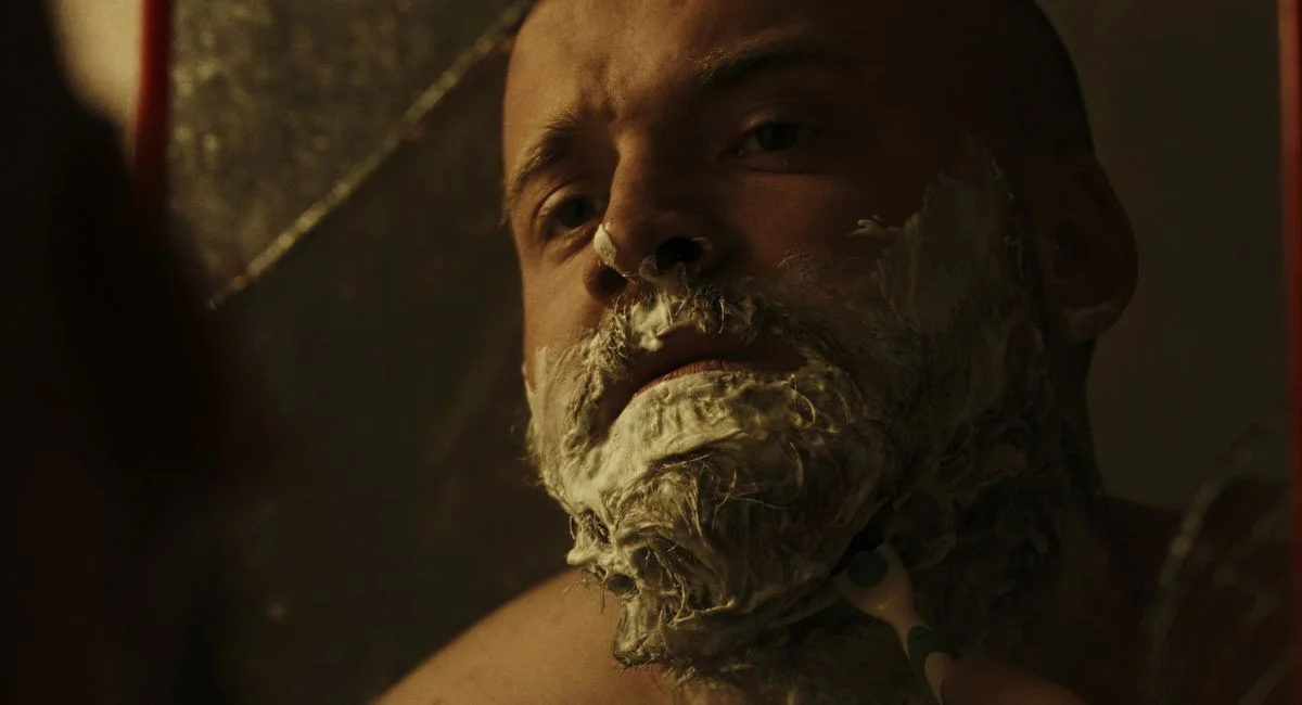 Close-up of a man shaving with cream, reflecting in a mirror in Istanbul, Turkey.